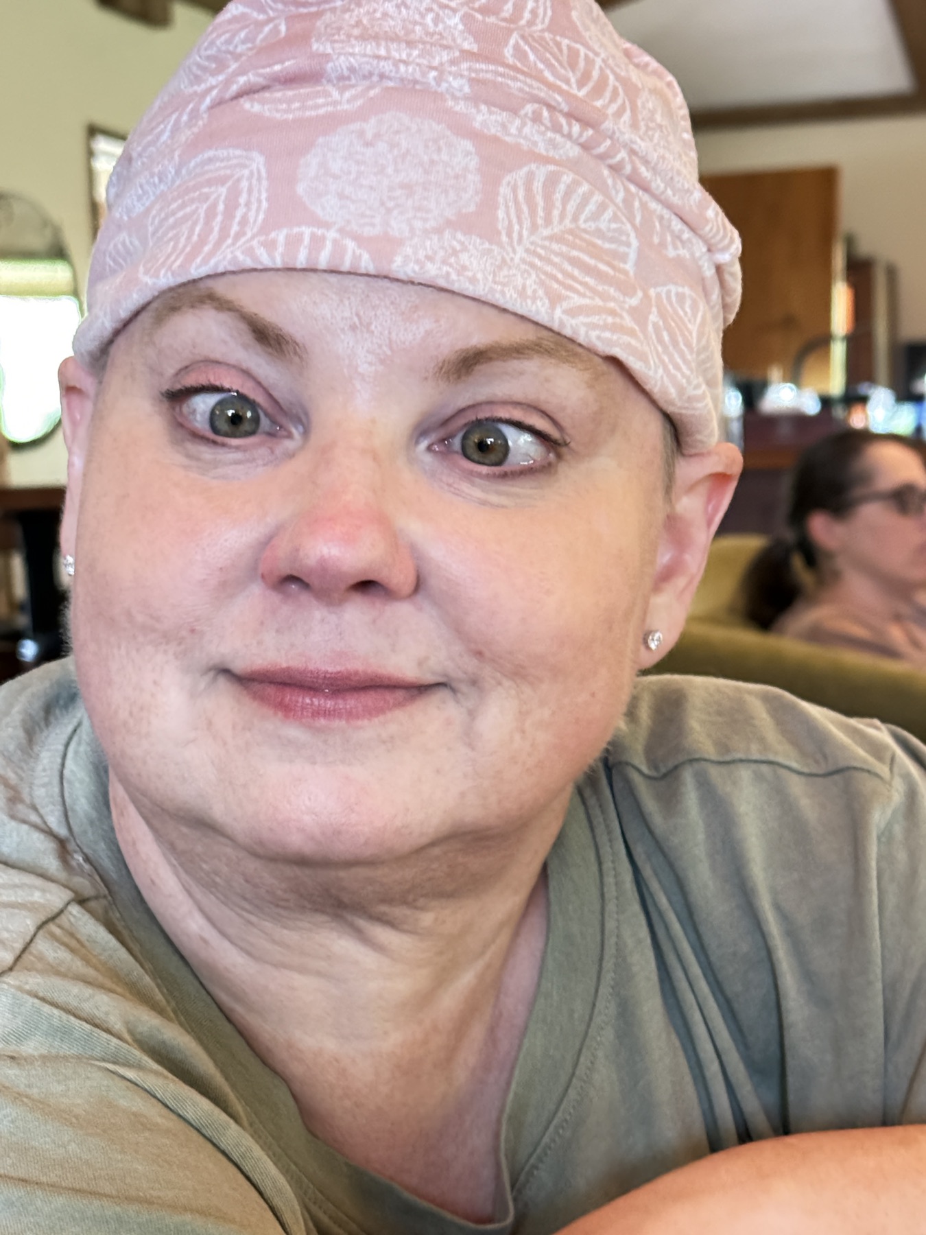 A close, tender portrait of Amy in a soft pink head scarf.